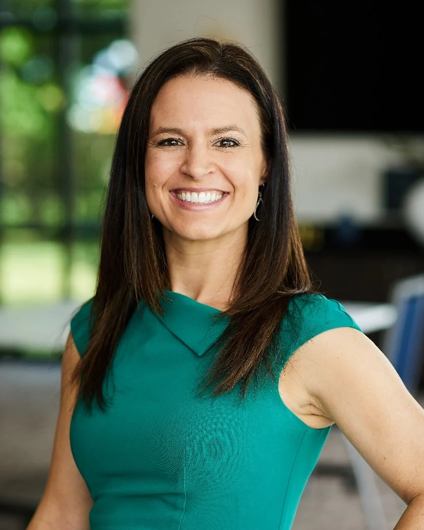 Christen M. Jeschke smiling in a green dress