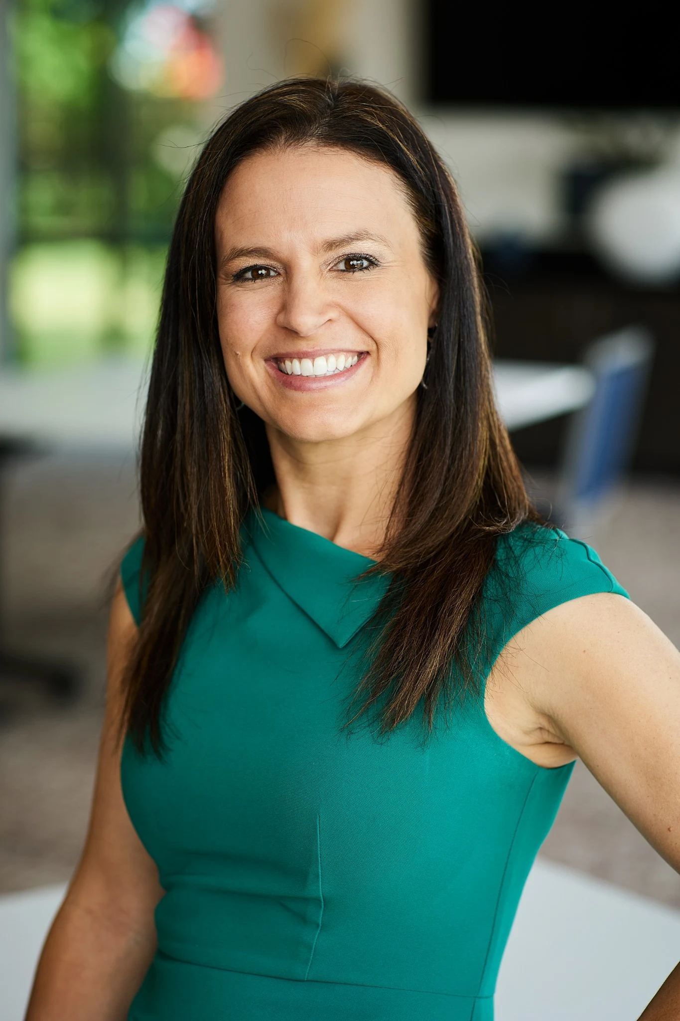 Christen M. Jeschke smiling warmly in a green dress